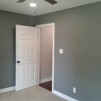 User comments Empty room with gray walls, beige carpet, a white door partially open, and a ceiling fan with a light.